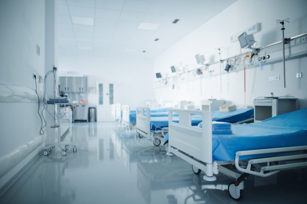 Worried patient in a busy emergency room as doctors work urgently to provide critical care.